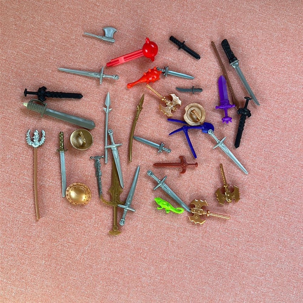 Lot of small Barbie-sized toy action figure weapons knives shields